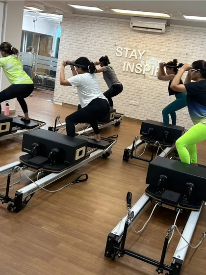Various shots of members and instructors in action during our dynamic Reformer Pilates classes.