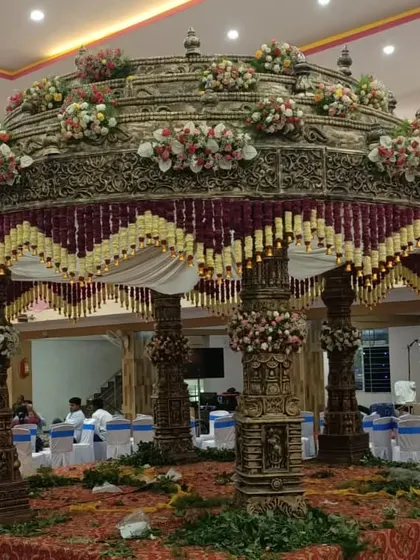 I specialize in creating magnificent, traditional mandaps that become the heart of the wedding ceremony. This is an example of an intricate South Indian mandap, showcasing detailed craftsmanship and floral decoration for a grand celebration.