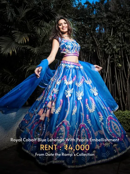 Make a bold statement with this royal cobalt blue lehenga with pearl embellishments. A beautiful contrast to traditional Haldi colors.