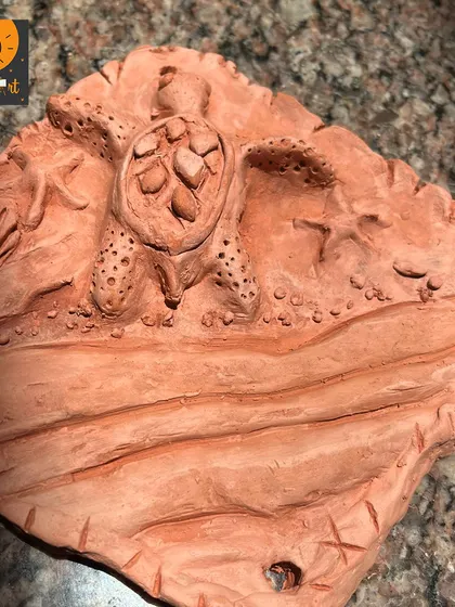 Another beautiful clay mural of a sea turtle, with intricate details carved into the surface. These projects allow for so much creativity and personal expression.