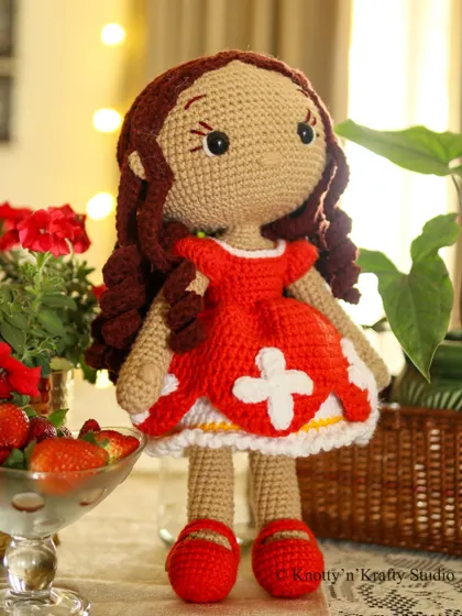 Another look at Lily, my handmade crochet doll. I take great care in crafting the details, from her curly hair to her little red shoes.
