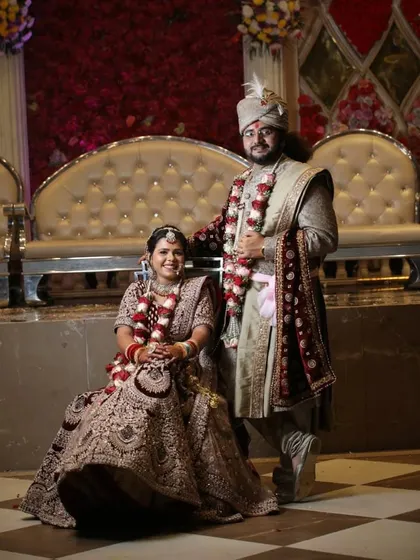 This couple chose a unique color palette with a mauve and brown embroidered lehenga and a matching sherwani. It's a beautiful, earthy look for a wedding ceremony.