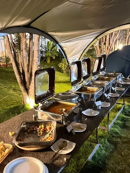 No adventure is complete without great food. We provide a full buffet spread for your team, ensuring everyone is well-fed and energized for the day's activities. This image shows one of our outdoor dinner setups.
