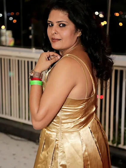 A back view of the golden satin dress, with its delicate spaghetti straps.