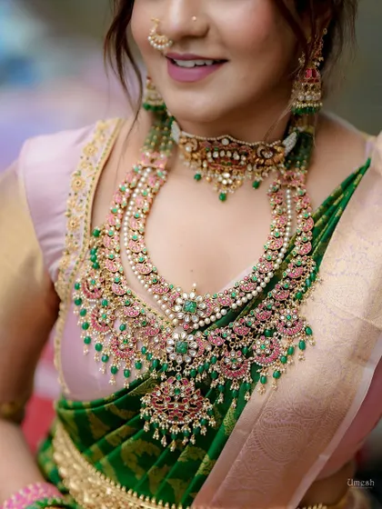 A close-up of the stunning layered necklace. The combination of pink and green stones with pearls is a classic and popular choice.
