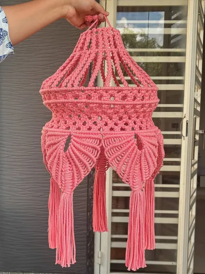 This beautiful pink macrame lantern is perfect for the festive season. The intricate design and tassels add a warm, bohemian glow to any space.