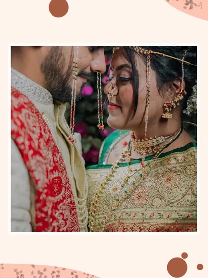 An intimate close-up of a Maharashtrian couple. The traditional mundavalya frames their faces as they share a quiet moment, nose to nose.