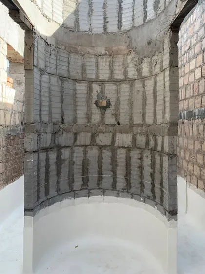 An unfinished, curved space at the House of Galleries. This image captures the raw beauty and potential of the structure during the construction phase.