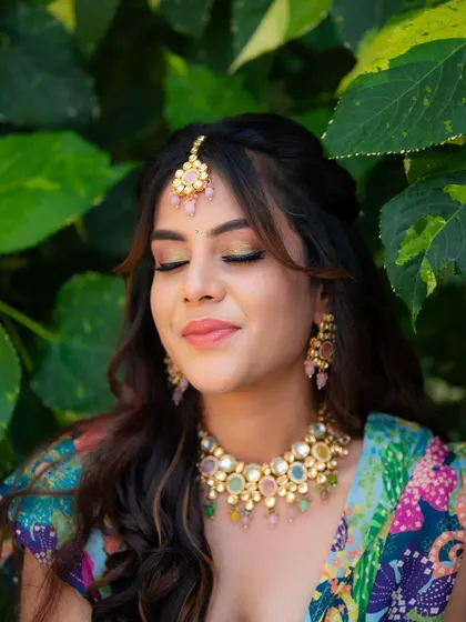 A serene moment with eyes closed, showing off the beautiful eye makeup. This shot highlights the artistry of the makeup artist and the bride's calm happiness.