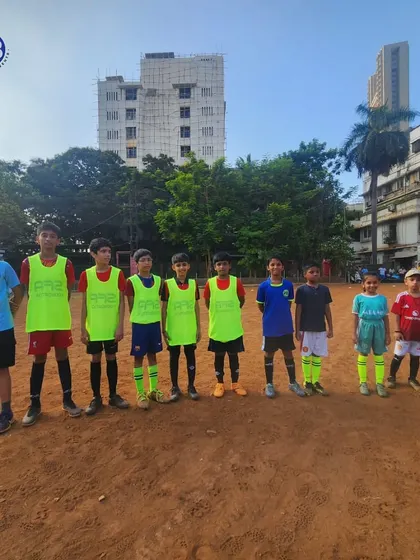 A group of our young footballers ready for a practice match. Wearing bibs to distinguish teams, they are prepared to put their training into action and compete.