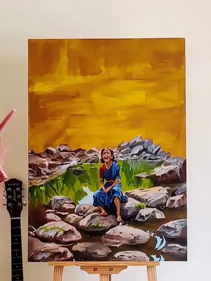 The nearly completed painting, 'From the eyes of a woman', resting on the easel. This artwork, set against a warm, expressive sky, aims to capture a feeling of freedom and uninhibited expression.