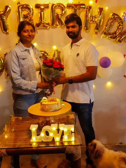 Celebrating love with a simple yet beautiful setup. This decoration includes "Happy Birthday" balloons, fairy lights, and a light-up "LOVE" sign, perfect for an intimate at-home surprise.