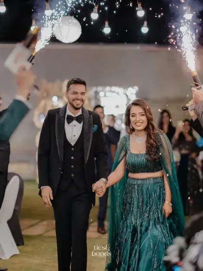 A grand entrance for the couple at their Sangeet, walking through an aisle of friends holding cold pyro sparklers. I love creating high-energy, celebratory entrances.