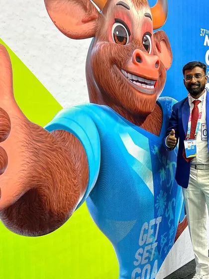 Standing next to the mascot at the National Games. It is a privilege to be part of such a major national sporting event.