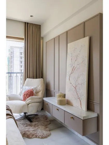 A view of the seating area in the bedroom. The comfortable armchair, soft rug, and custom console with 3D artwork create a perfect corner for relaxation and quiet contemplation.