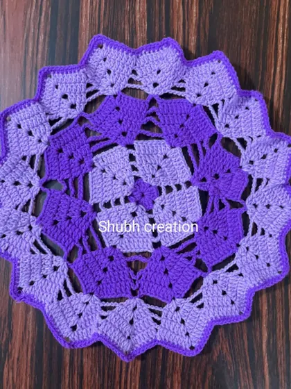 An intricate geometric table mat made with two shades of purple, creating a beautiful tessellated pattern.