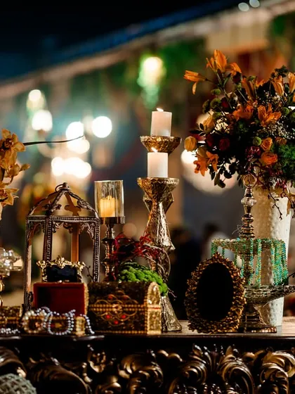 A beautifully styled console table featuring vintage treasures, candlelight, and floral arrangements. These detailed vignettes added a layer of refined elegance to the rugged, ancient theme.