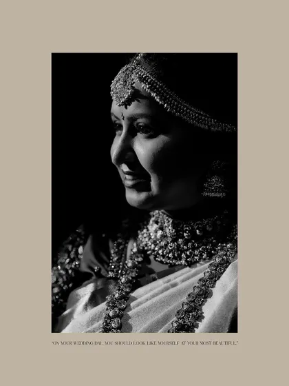 A classic black and white profile shot of the bride. The high-contrast lighting beautifully sculpts her features and highlights her intricate jewelry.
