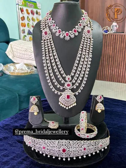 A complete AD and ruby bridal set, including a layered haaram, choker, vaddanam, and bangles.