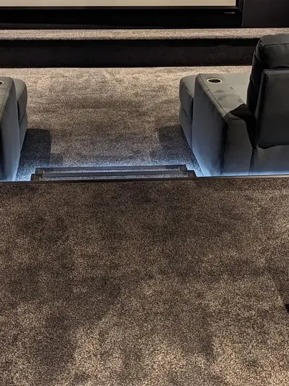 A close-up of the plush carpeting and illuminated steps. The soft flooring helps with sound absorption, and the lighting ensures safety in a dark room.