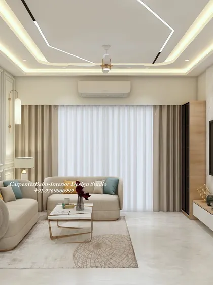 This view shows the interplay of different lighting sources, from the false ceiling LEDs to the hanging pendant lights, all working together to create a bright and welcoming living area.