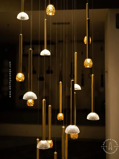 This cluster pendant features a mix of gold-toned rods with textured glass shades, some resembling pineapples and others simple domes. The combination creates a visually interesting and warm installation for any corner that needs a lift.