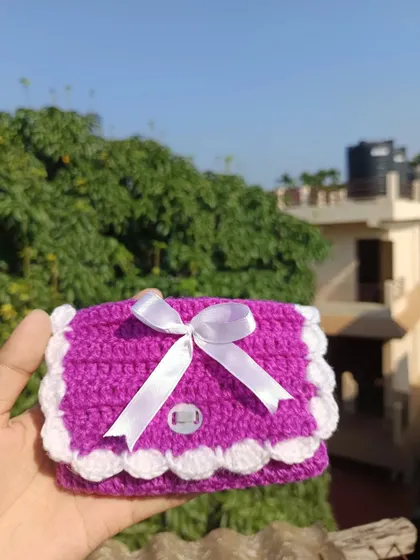 A vibrant purple mini purse with a white scalloped edge and ribbon. This was a custom color request that turned out beautifully.
