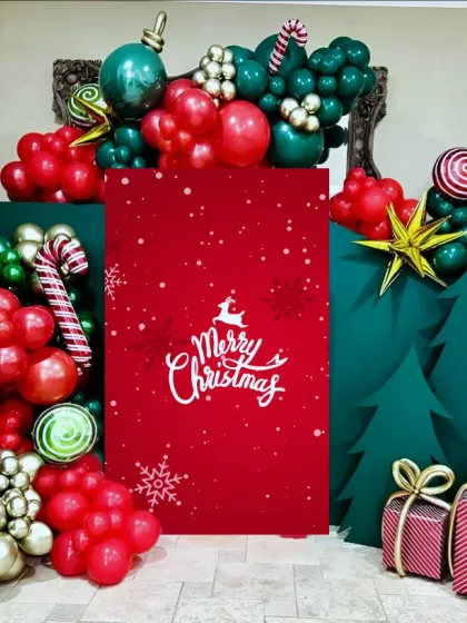 Photo booths are a must have for any celebration. I designed this whimsical Christmas photo corner using a combination of balloon art to create candy canes and ornaments, custom-cut trees, and a bold red backdrop. It’s a fun, festive, and perfectly Instagrammable addition to any corporate holiday party.