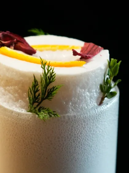A macro shot of the incredible, stable foam证据 of our Ramos Gin Fizz, a testament to the technique and patience of our bartenders.