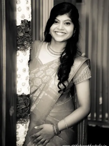 A beautiful black and white portrait of a wedding guest, showcasing her natural smile. We capture the joy of not just the couple, but their loved ones too.
