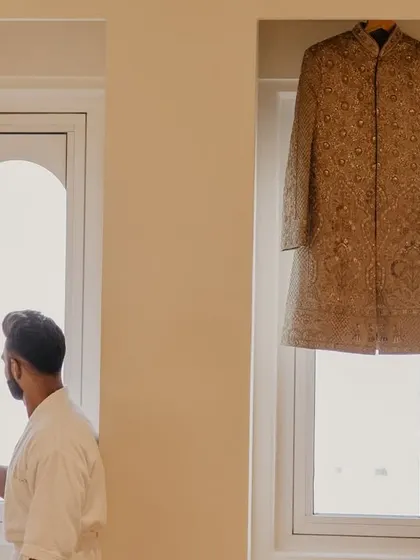 The groom enjoying a quiet moment with a cup of coffee before getting into his wedding sherwani.