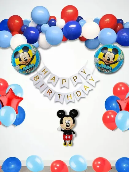 A simple and classic Mickey Mouse themed birthday setup with a balloon garland and character foils.