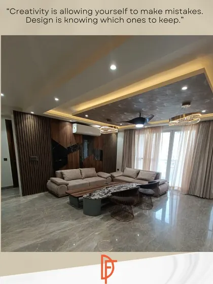 A finished living room from one of our projects, showcasing a blend of dark wood paneling, a textured ceiling, and comfortable, modern furniture. This demonstrates our ability to create tailored, contemporary spaces.