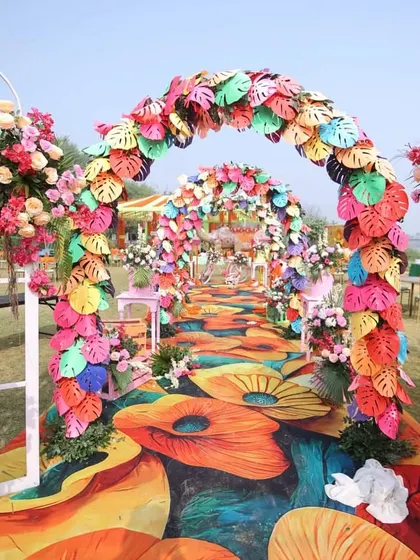 An absolutely stunning entrance walkway made with colorful artificial leaves and flowers. I can create highly customized and unique decorations for any event.