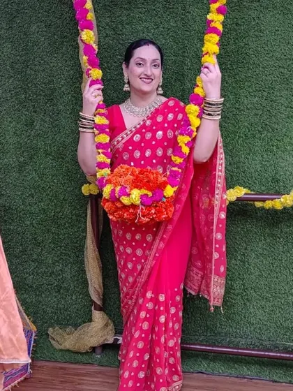 One of our members enjoying the decorated swing during our Teej festivities.