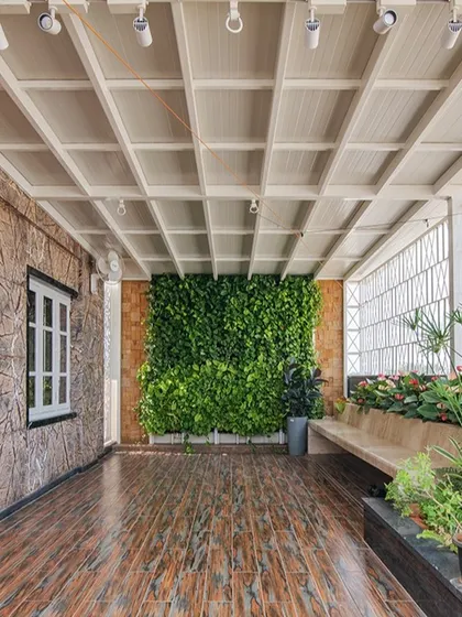 A wide view of the 'Opulent Abode' terrace. The space is designed for versatility, with an open floor area for activities like yoga, surrounded by a vertical garden and planters.
