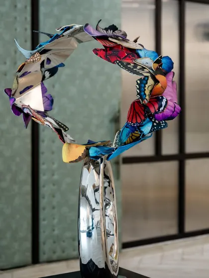 A side view of "Flight to Infinity," demonstrating its elegant, circular form and the sense of perpetual motion it creates.