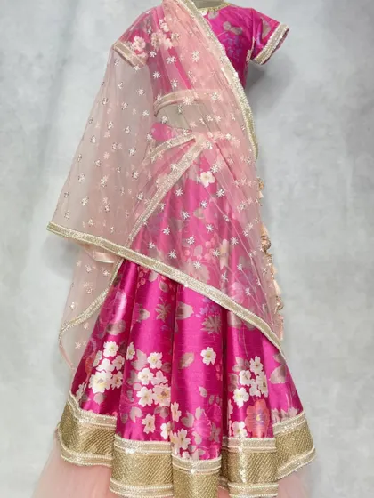 A full view of the in-house printed floral lehenga, showing how the soft net dupatta and layered skirt create a dreamy, romantic effect.
