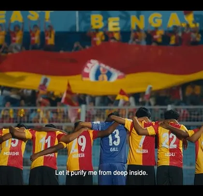 A powerful image of the East Bengal FC team standing together, united. This shot showcases the custom jerseys and the strong sense of camaraderie.