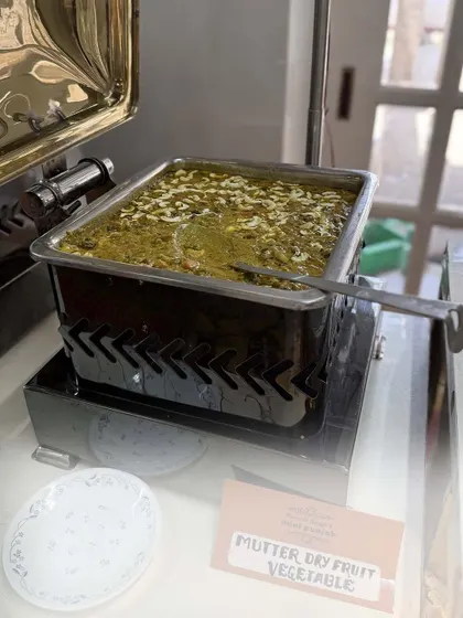 This is my Mutter Dry Fruit Vegetable, a unique and rich dish from my menu. The label shows my commitment to clearly identifying each dish for the convenience of my guests.
