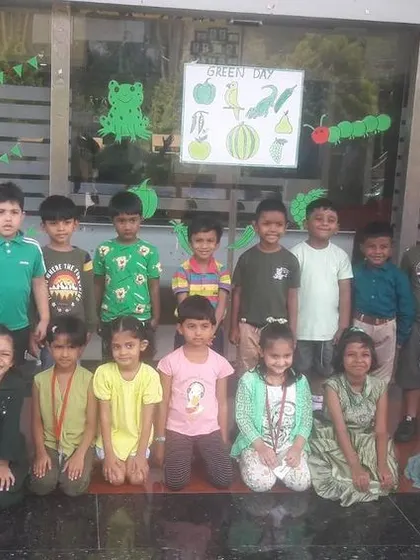 Students and teachers come together for a group photo, all celebrating Green Day and the importance of our environment.