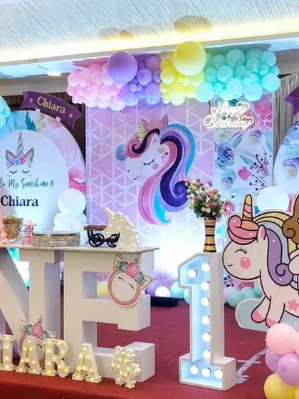 A unicorn-themed first birthday for Chiara with large 'ONE' letters.