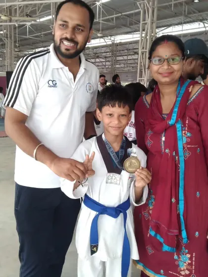 A young blue belt student celebrating his gold medal win at the 4th National Sikh Games.