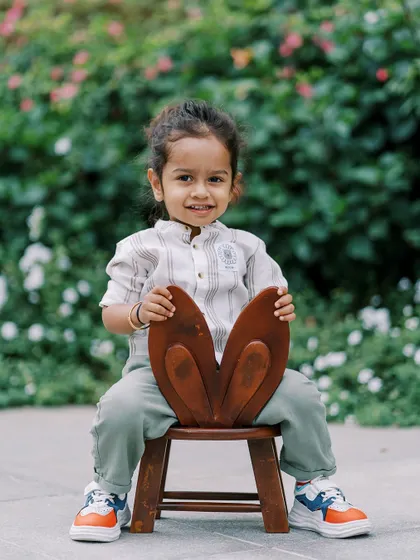 A little boy with a bunny-eared chair. Fun props can bring out the playful side of any child.