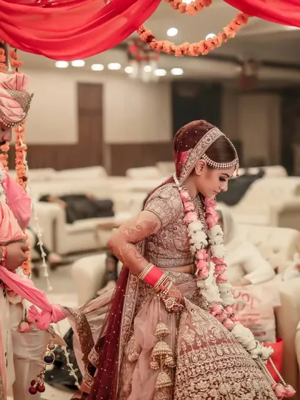 Capturing the Gathbandhan ritual during the wedding ceremony, where the couple's garments are tied together, symbolizing their sacred union.