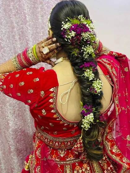 A side view of the floral braid, highlighting how the flowers are woven through the hair.