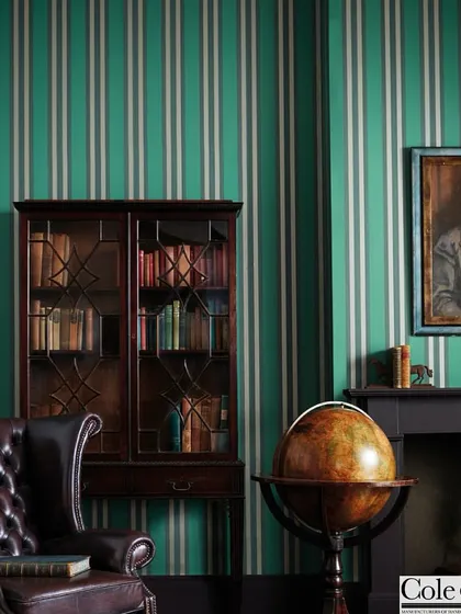 The quintessential striped wallpaper from Cole & Son offers a touch of classic British elegance. Set in a traditional study, its clean lines and sophisticated colorway create a sense of order and refinement, proving the enduring power of a simple, well-executed pattern.