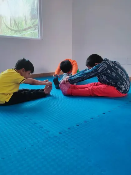Our kids' fitness class in progress, with students focusing on their stretching routines. A strong and flexible body is the foundation of a good martial artist.