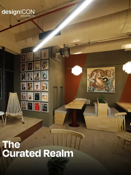 The 'Curated Realm' at the Innov8 coworking space. This eclectic breakout area features a gallery wall, unique wooden chairs, and built-in booth seating, creating a warm and artistic atmosphere.