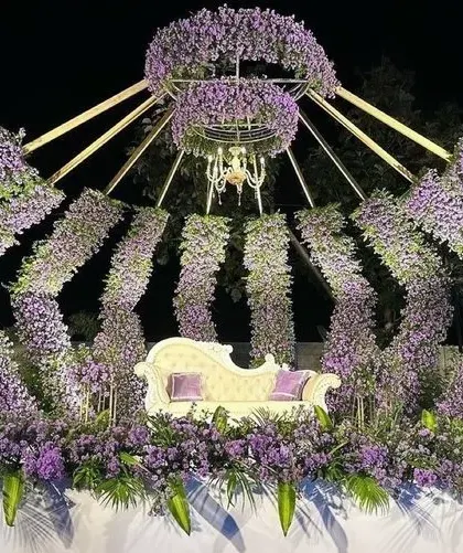 For a truly unique reception, we designed this royal crown-inspired stage. The structure is made of arches densely packed with purple flowers, with a beautiful chandelier at the center. It’s a bold and unforgettable backdrop that will make you feel like royalty on your special day.